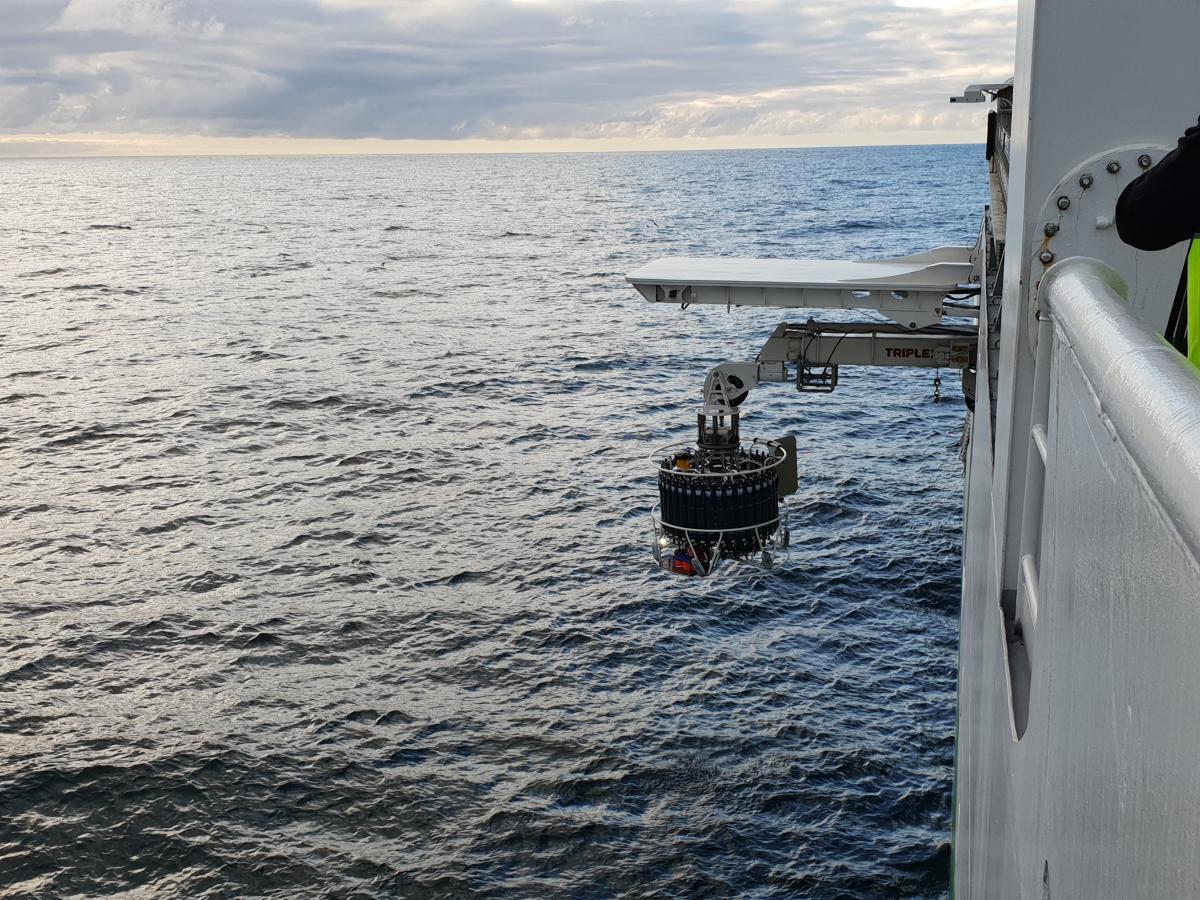 A water sampling instrument being deployed from a ship