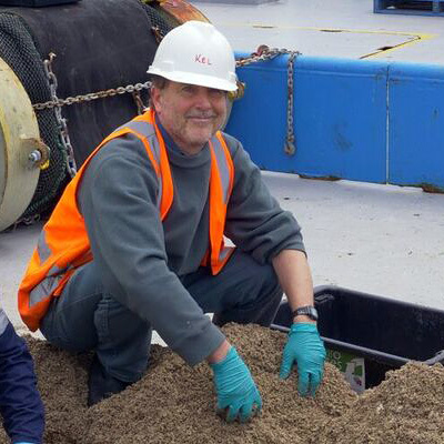 Simon Grove on deck with a pile of shell grit